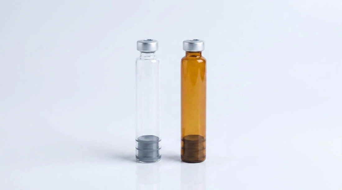 Clear and amber 3 ml glass pen cartridges standing side by side on a studio background