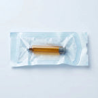 Amber 3 ml glass cartridge individually sealed inside its transparent self-sealing sterilization pouch, film side up