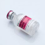 30 ml bacteriostatic water vial lying at a diagonal with the pink Hospira label facing the camera
