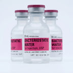 Three 30 ml Pfizer Hospira bacteriostatic water vials arranged on a pale studio backdrop