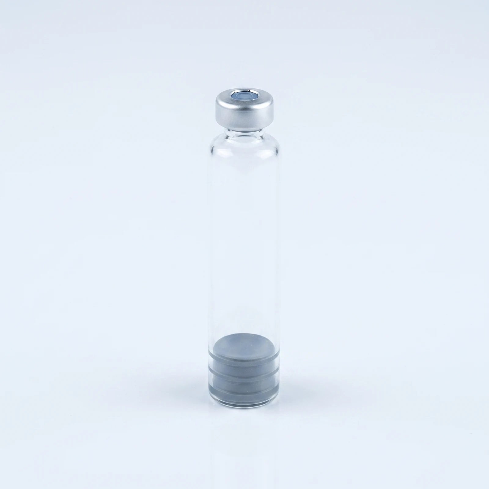 Eye-level view of the 3 ml glass pen cartridge standing upright with crimp cap on top and plunger at the base