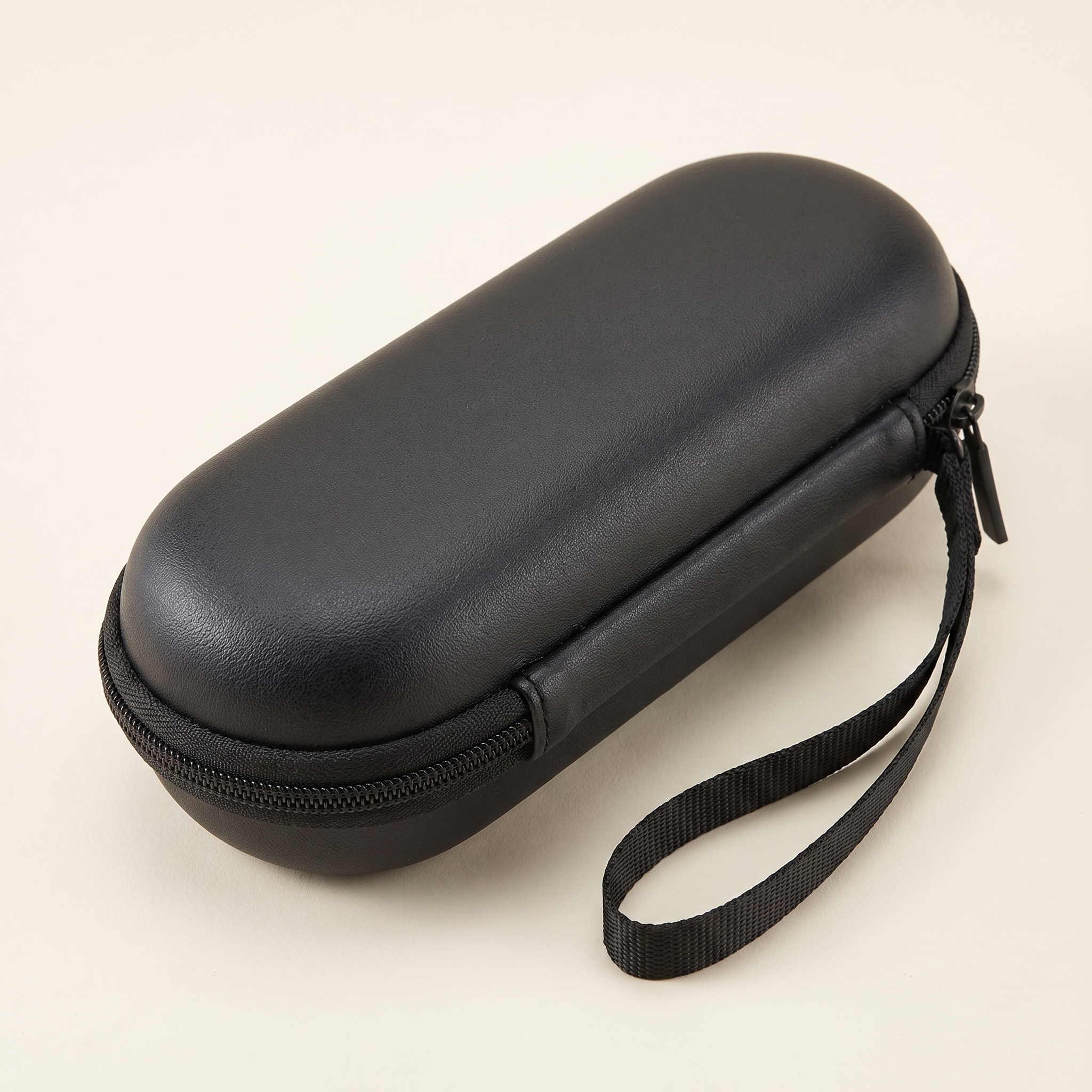 EVA travel case, closed, black hard shell with wrist strap