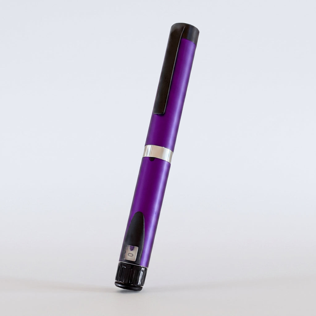 Purple V3 Peptide Pen, reusable aluminium click-dial pen, angled diagonally on a pale studio background