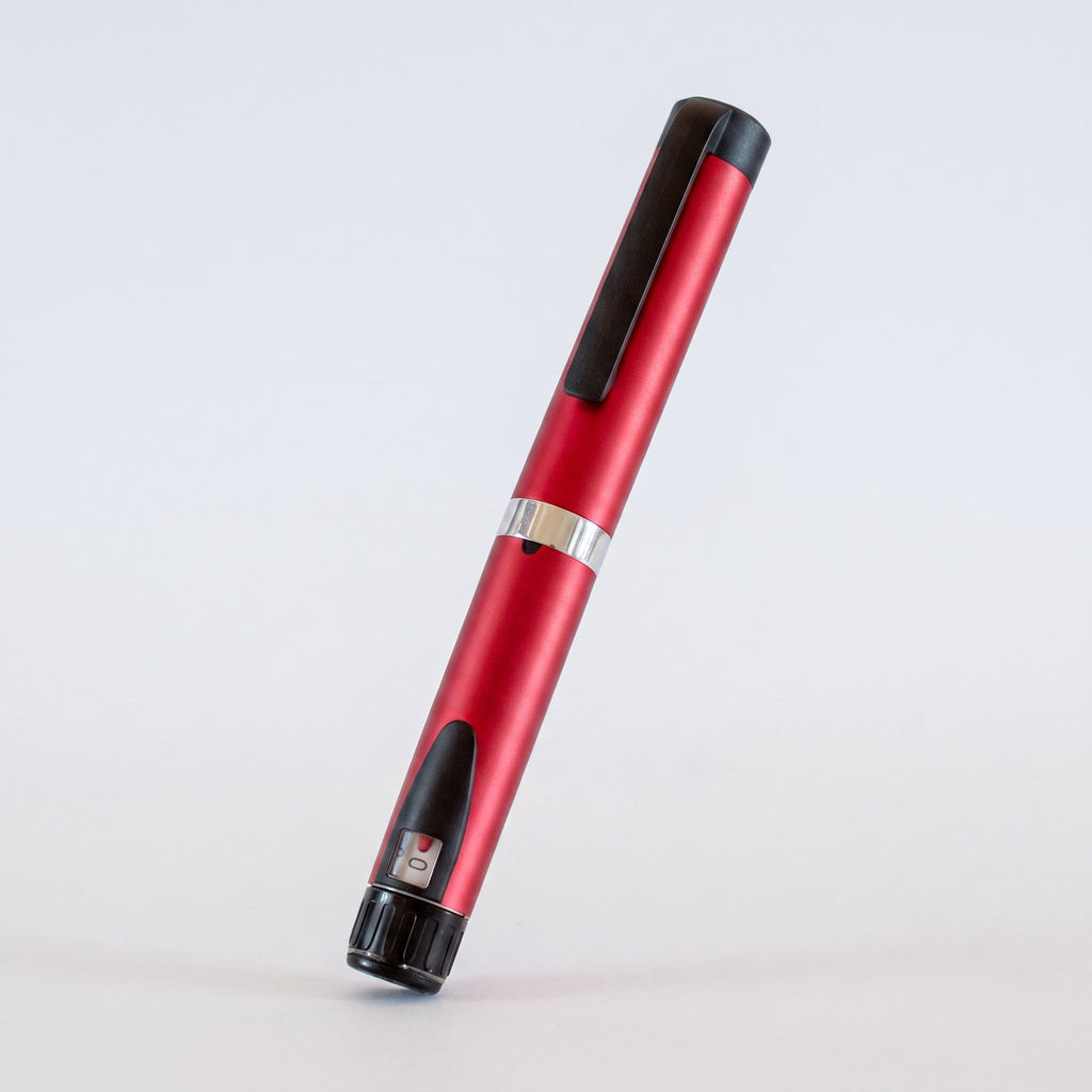Red V3 Peptide Pen, reusable aluminium click-dial pen, angled diagonally on a pale studio background