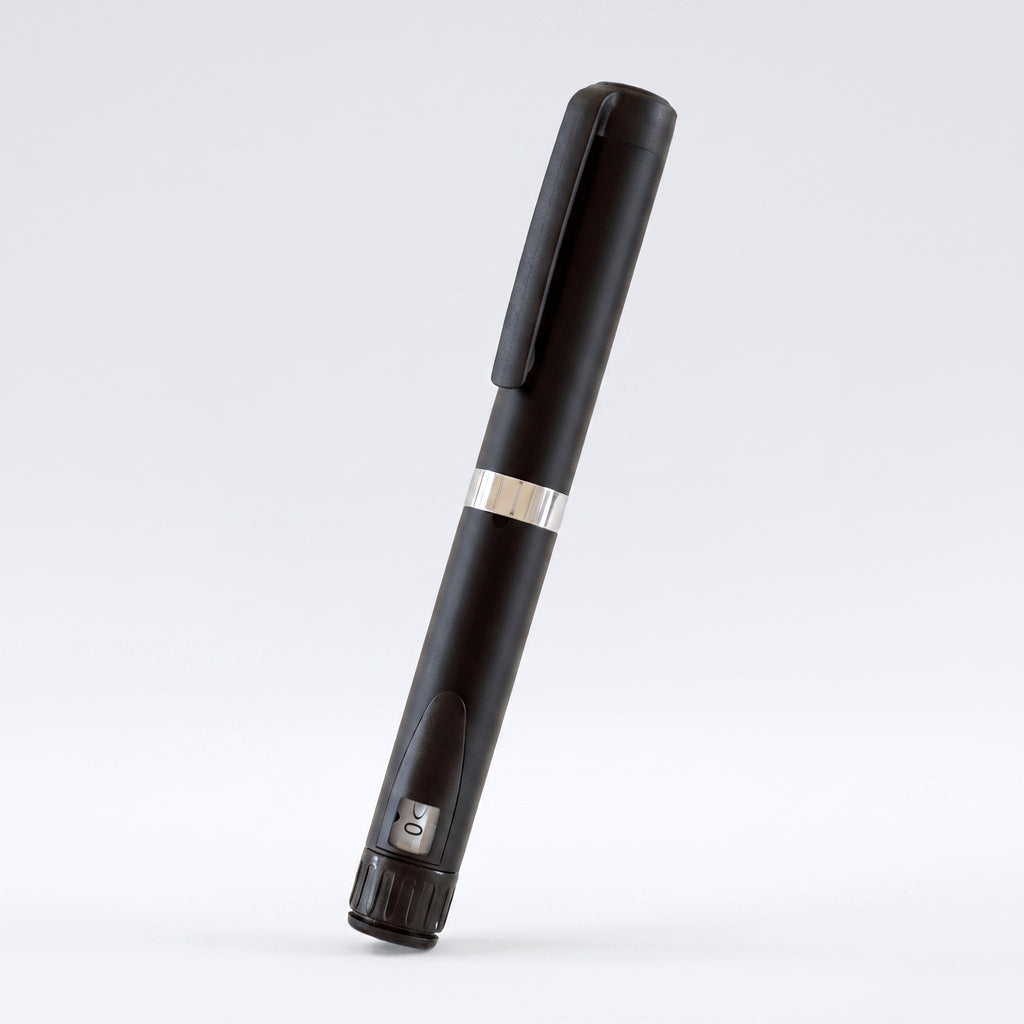 Matte black V3 Peptide Pen, reusable aluminium click-dial pen, angled diagonally on a pale studio background
