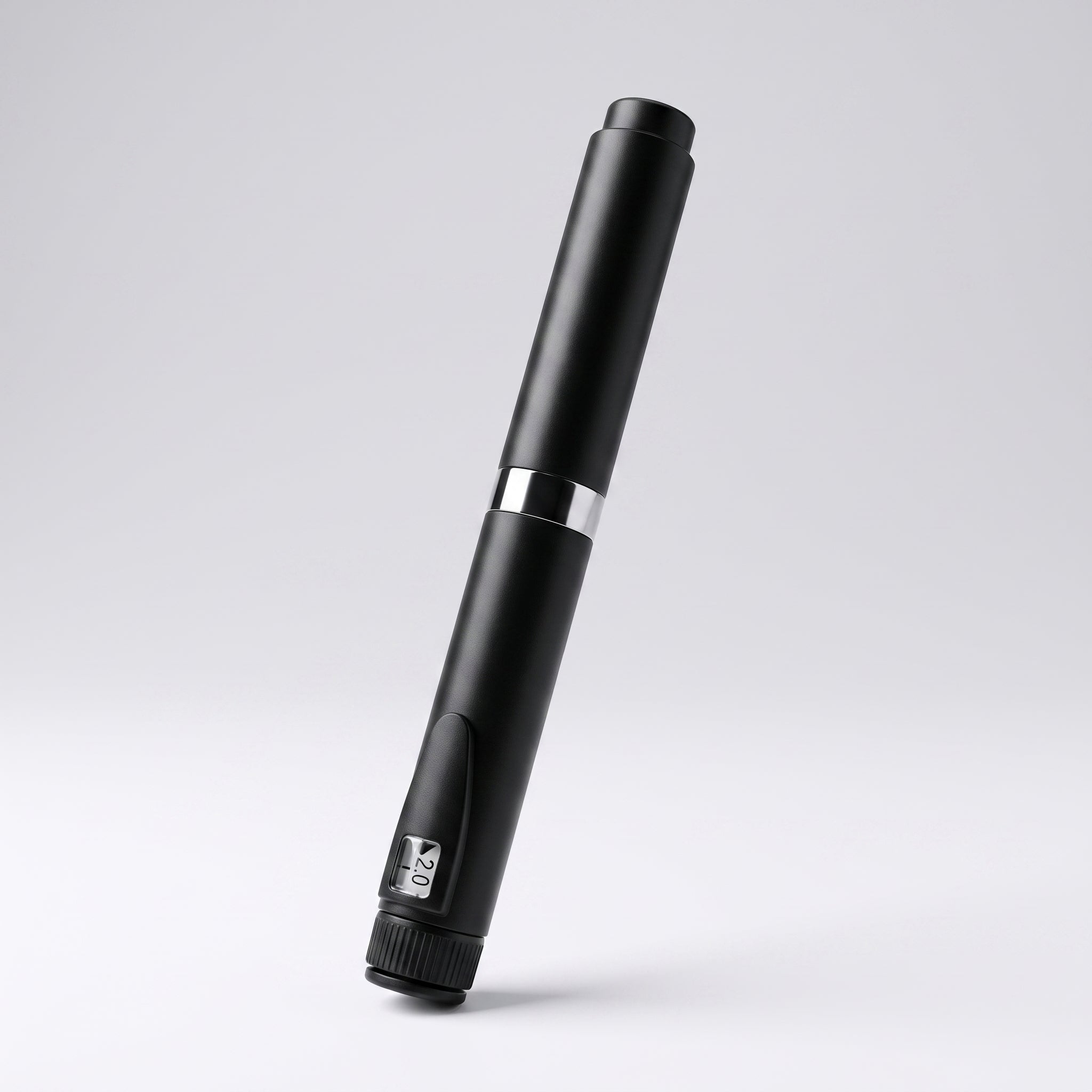 Matte black V2 Peptide Pen, reusable 60-unit pen with needle shield, angled diagonally on a pale studio background