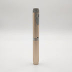 Champagne V2 Peptide Pen, reusable 60-unit pen with needle shield, standing upright with its chrome mid-band visible