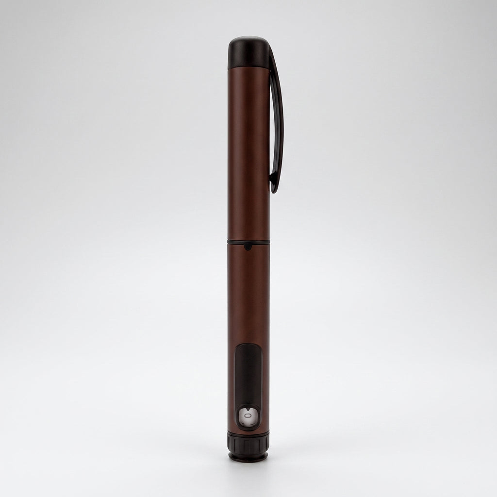 Dark brown V1 Peptide Pen, reusable manual click-dial pen, standing upright on a pale studio background