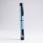 Light blue V1 Peptide Pen, reusable manual click-dial pen, standing upright with the dose window visible near the base