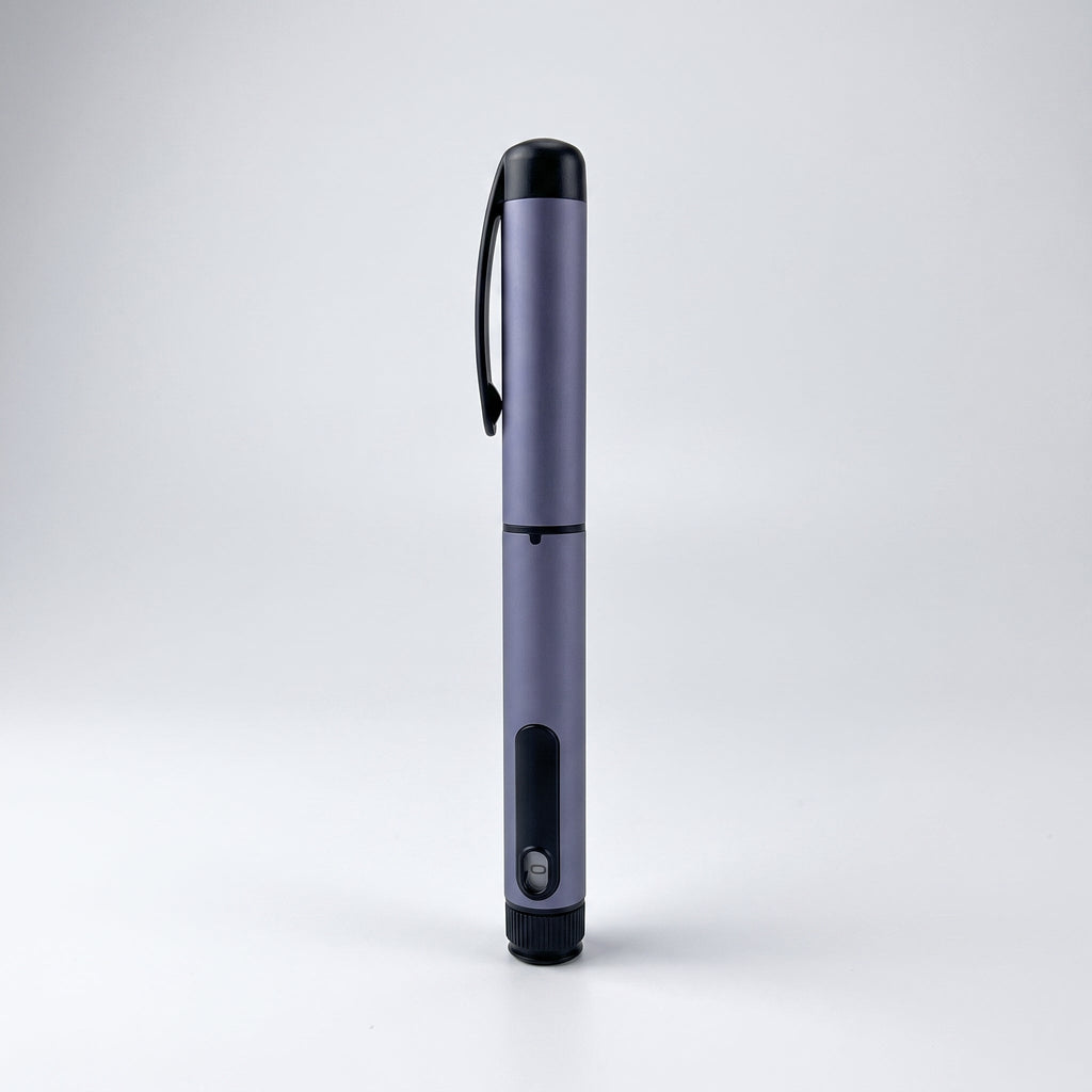 Slate grey V1 Peptide Pen, reusable manual click-dial pen, standing upright on a pale studio background