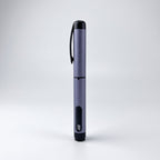 Slate grey V1 Peptide Pen, reusable manual click-dial pen, standing upright on a pale studio background