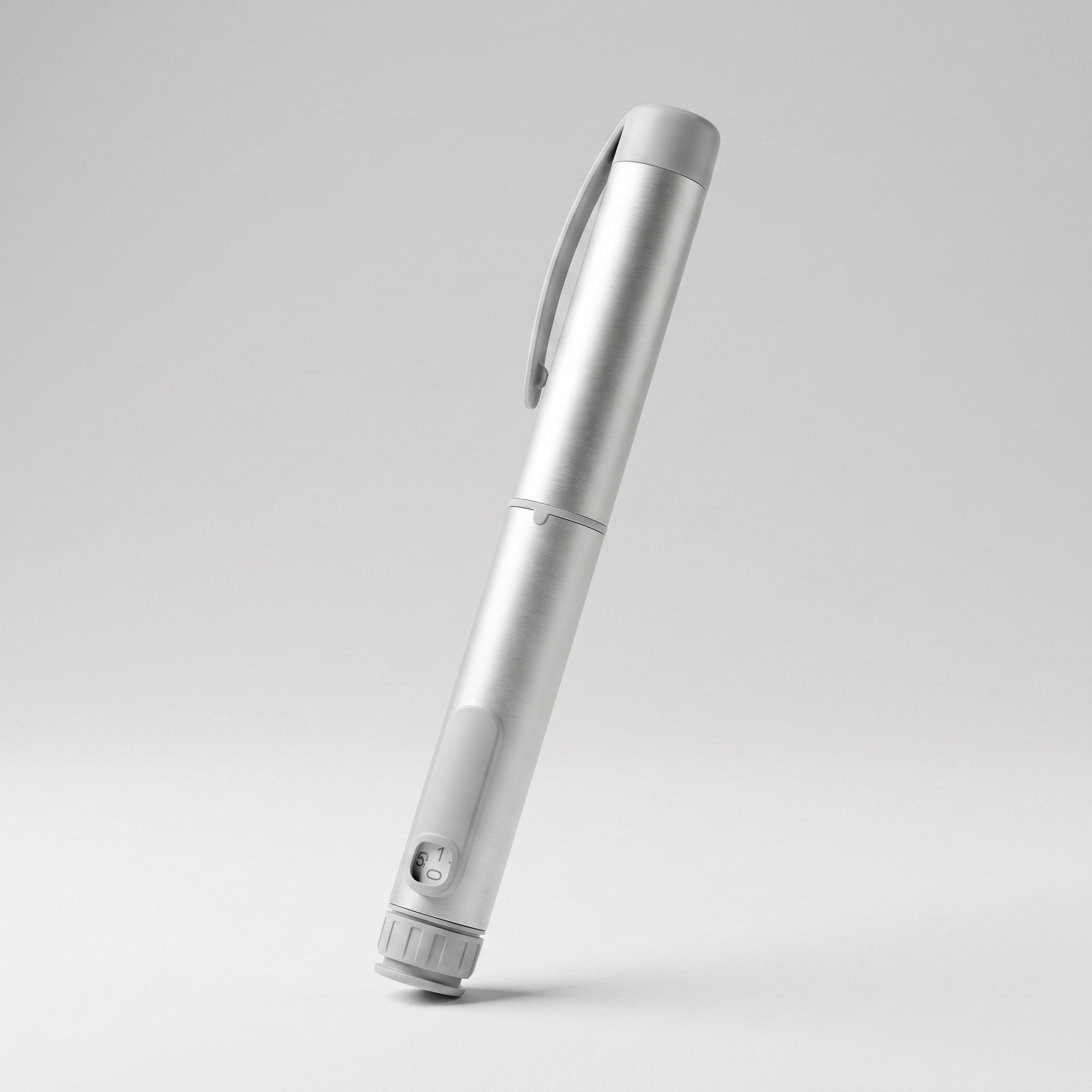 Brushed silver V1 Peptide Pen, reusable manual click-dial pen, angled diagonally on a pale studio background