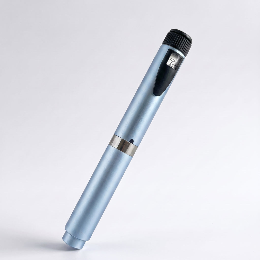 Ice blue V2 Peptide Pen, reusable 60-unit pen with needle shield, angled diagonally on a pale studio background