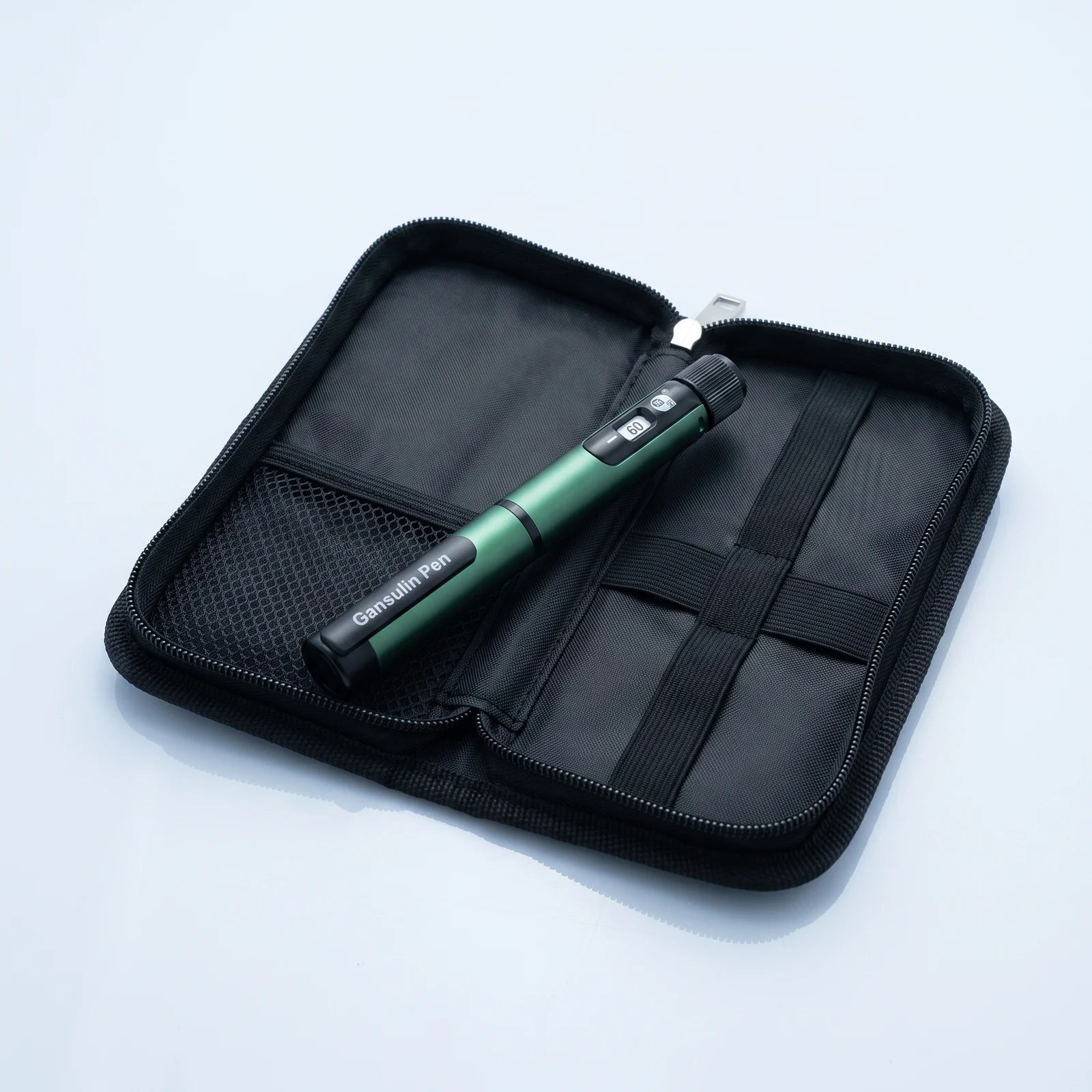Gansulin pen resting in its open black zip case with elastic loops and mesh pocket