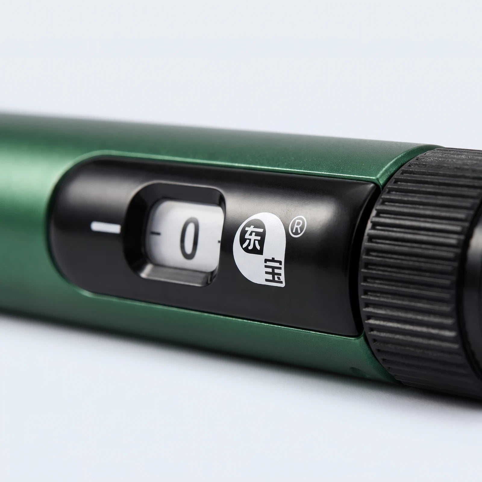 Macro of the Gansulin pen's dose window showing 0, dongbao badge and knurled dosage knob