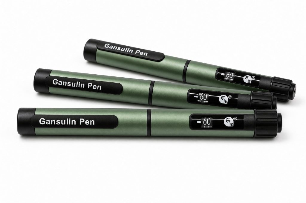 Three capped Gansulin pens laid out diagonally on a pale studio background